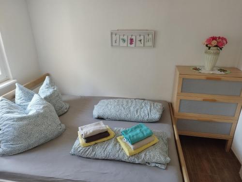 a bed with two pillows on top of it at Bungalow am Schwielochsee 1 in Schwielochsee