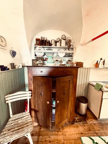 a kitchen with a wooden cabinet with pots and pans at Idyllische Almhütte am Gaberl in Kleinlobming