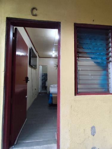a hallway leading to a room with a door at TerisitaPlace - BamboRoom in Taytay