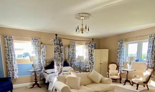 a living room with a bed and a couch at Rossmanagher House in Bunratty