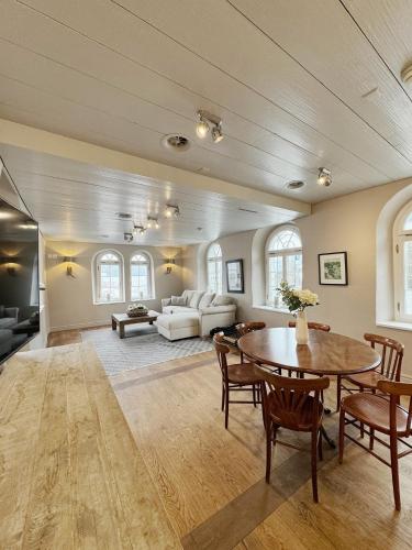 a living room with a table and a couch at Hotel Hirschen am See in Meilen