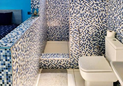 a bathroom with a toilet and a sink at Modern luxury 4-Bedroom Villa with Private Pool, BBQ flic en flac in Flic-en-Flac