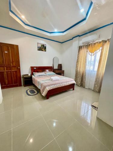 a bedroom with a bed in a room at Drage Tourist Inn in Logon