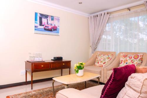 a living room with a couch and a table at Dikalo Highston Boutique Guest house in Bryanston Sandton Johannesburg in Johannesburg