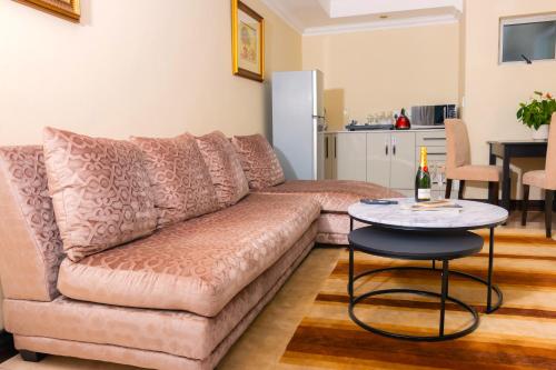 a living room with a couch and a table at Dikalo Highston Boutique Guest house in Bryanston Sandton Johannesburg in Johannesburg