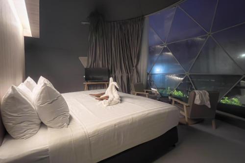 a bedroom with a bed with a dog laying on it at Sunny Side Resort Koh Tao in Koh Tao