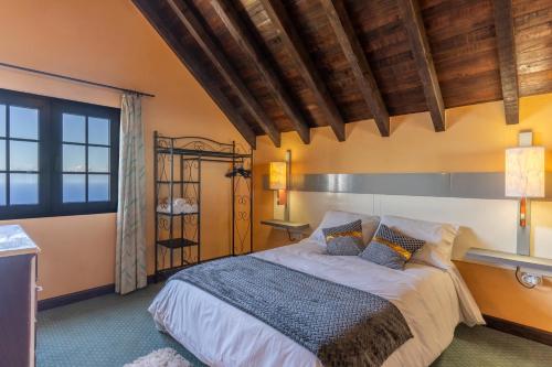 a bedroom with a large bed in a room at Sunset Village by Holiday Rental Madeira in São Jorge