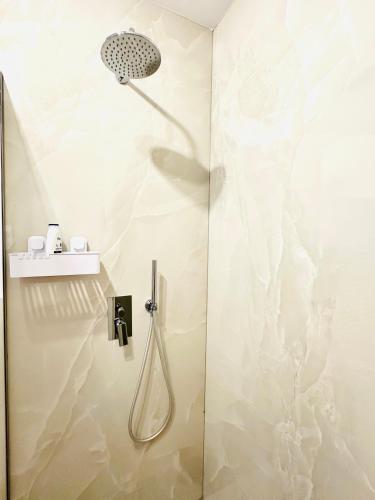 a shower with a shower head in a bathroom at Central Grand Apartment in Timişoara