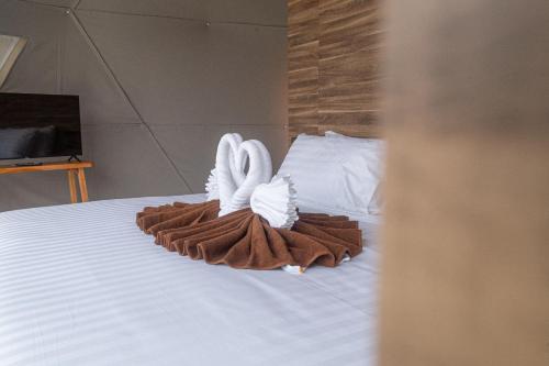 two towel rabbits sitting on top of a bed at Sunny Side Resort Koh Tao in Koh Tao