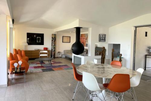 - un salon avec une table et des chaises orange dans l'établissement Villa moderne avec belle vue mer, à Porto-Vecchio