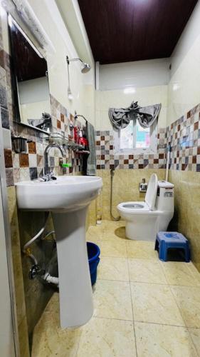 a bathroom with a sink and a toilet at Chomolungma Paribesh Trimarg in Khadkagaon