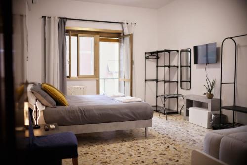 a bedroom with a large bed and a window at A Casa di Rocco in Rome