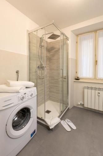 a washing machine in a bathroom with a shower at Residence Arco in Trieste
