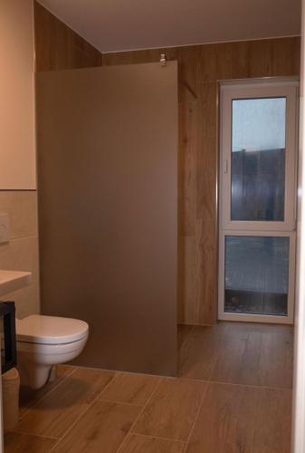 a bathroom with a toilet and a window at Mein Träumchen Apartments - 1 gelb gemütlich zentral in Bielefeld