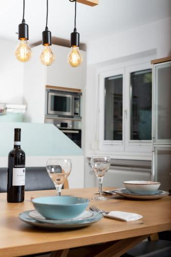 a table with two glasses and a bottle of wine at Ferien im Paradies - Wohnung Prima in Höchst