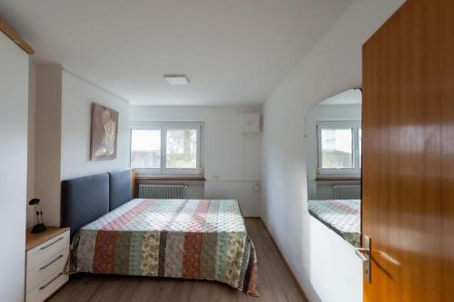 a bedroom with two beds and a mirror at Ferien im Paradies - Wohnung Prima in Höchst