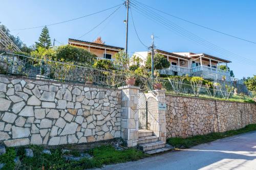 a house on top of a stone wall at Dolphin villa 1 in Gaios