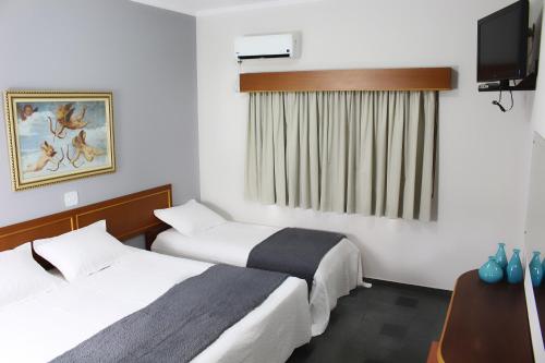 Ένα ή περισσότερα κρεβάτια σε δωμάτιο στο ARQ Inn Hotel