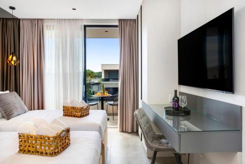 a hotel room with a bed and a desk and a tv at Fly Room - S7 - MPolo in Medulin