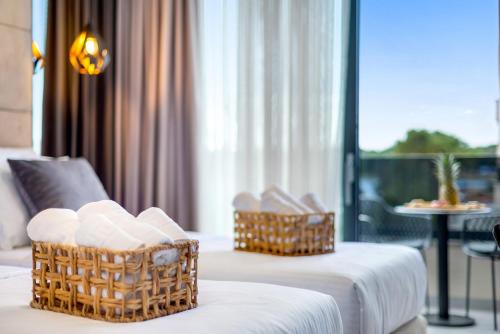 a hotel room with two baskets on a couch at Fly Room - S7 - MPolo in Medulin