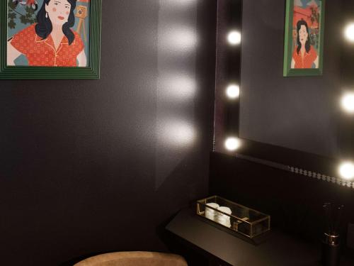 a bathroom with a toilet and a painting on the wall at Mercure Roma Cinecittà in Rome