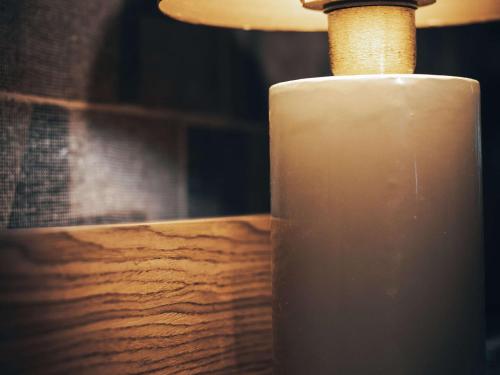 a candle sitting on top of a wooden table at Mercure Roma Cinecittà in Rome
