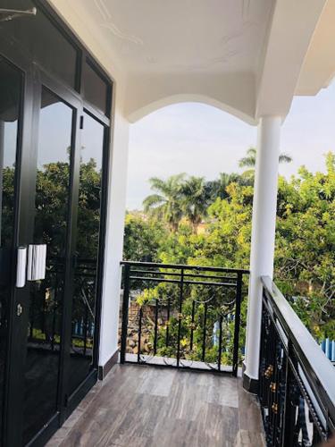 a balcony of a house with a view of trees at SONKOYAZ BED AND BREAKFAST Near UN BASE in Entebbe