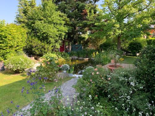 a garden with many different types of flowers at Auszeit - Wohnung mit Garten und Bergblick in Bad Aibling