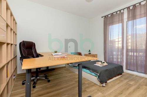 an office with a desk with a bed and a window at Luxurious Tsimiski 2nd Floor in Alexandroupoli