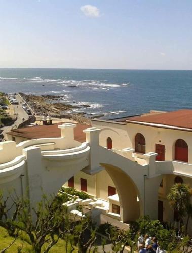 a view of a building with the ocean in the background at Pinpirinia min 3 nuits in Guéthary