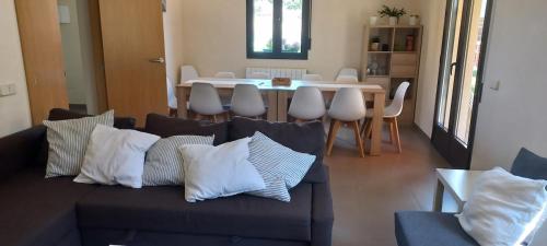 a living room with a couch and a dining room table at Mirador de Peña La Estrella in Ortigosa del Monte