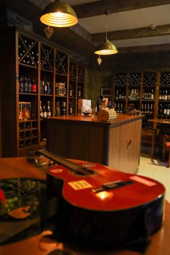 a red guitar sitting on a table in a bar at Sheki Palace Hotel in Sheki