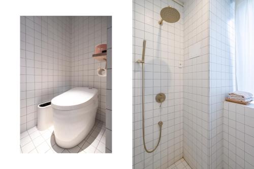 a bathroom with a toilet and a shower at YiXi Designer Hotel - Xi'an Bell Tower & Ming City Wall & T'ang Dynasty Ever-Bright City in Xi'an