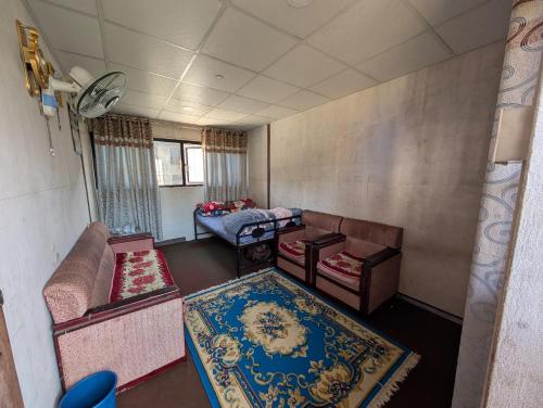 a living room with a couch and a table at Panauti Old Town Community Homestay in Panauti