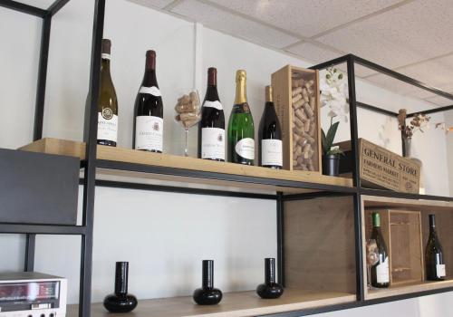 a bunch of wine bottles on a shelf at ibis Dijon Sud in Perrigny-lès-Dijon