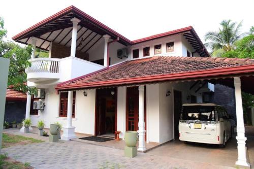 a white van parked in front of a house at Airport Blessings Villa in Katunayake