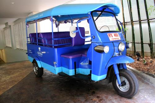a blue auto rickshaw parked in a garage at Park Plaza Bangkok Soi 18 in Bangkok