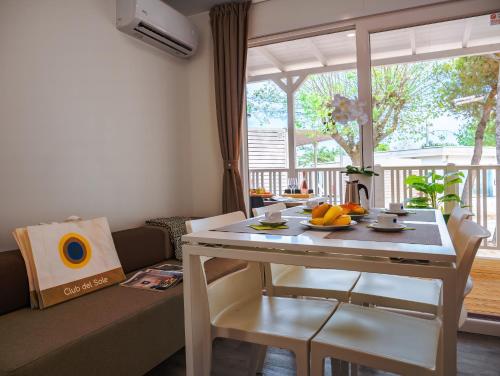 a living room with a table with fruit on it at Club del Sole Due Laghi Levico Family Collection in Levico Terme