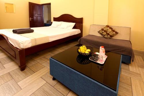 a room with two beds and a table with bananas on it at Namasthe Ayurveda and Yoga Retreat Cochin in Nedumbassery