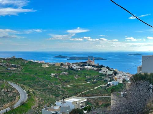 a view of a city and the ocean at Ano Syros Orient in Ano Syros