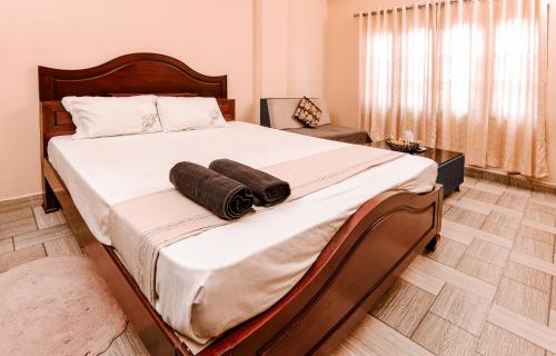 a bedroom with a large bed with two towels on it at Namasthe Ayurveda and Yoga Retreat Cochin in Nedumbassery