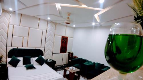 a glass of wine in a room with a couch at The Signature Hotel Multan in Multan