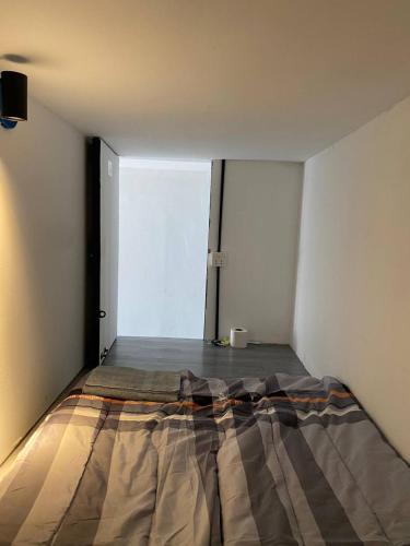 a bed in a room with a large window at The Moonvine on 360 in Phnom Penh