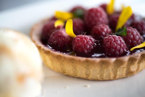a small tart filled with raspberries on a table at Bron Eifion Hotel in Criccieth
