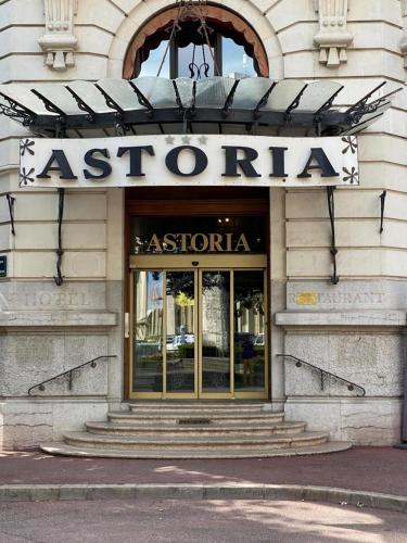 a building with a sign on the front of a store at Astoria city in Aix-les-Bains