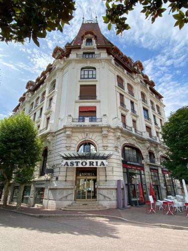 a large white building with a sign on it at Astoria city in Aix-les-Bains