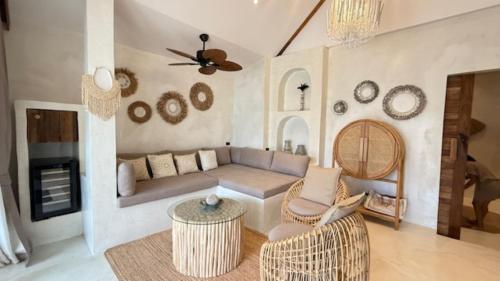 a living room with a couch and a table at Cape Beach Villa Samui in Ban Bang Po