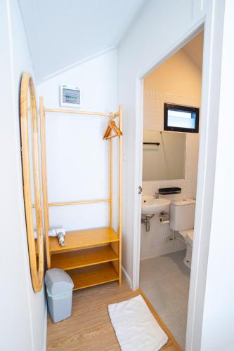 a small bathroom with a sink and a toilet at Chapter Pool Villa in Ban Hua Khao Sammuk