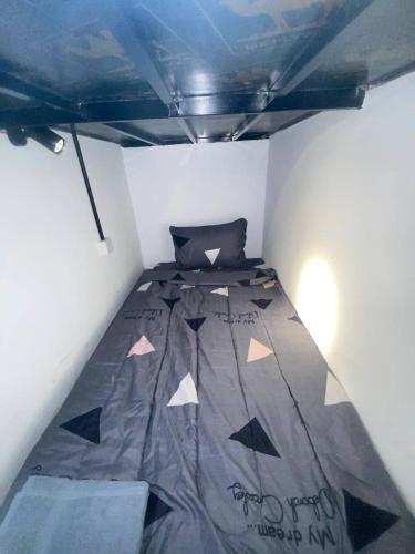 a small room with a bed in the ceiling at The Moonvine on 360 in Phnom Penh