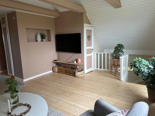 a living room with a flat screen tv on the wall at house with a view in Huskvarna